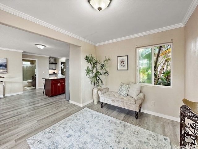 living area featuring crown molding and light wood-type flooring