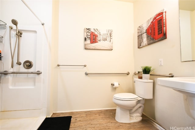 bathroom with hardwood / wood-style flooring and toilet