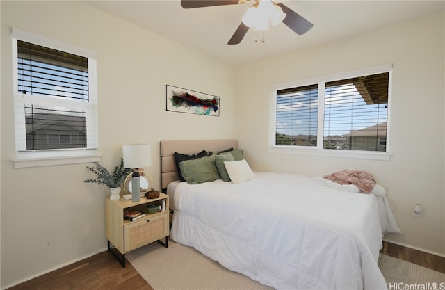 bedroom featuring ceiling fan and dark hardwood / wood-style flooring