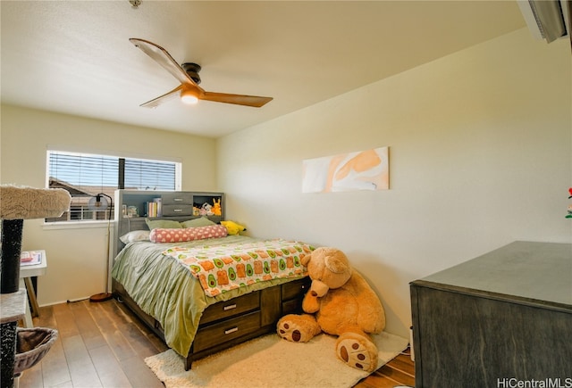 bedroom with ceiling fan and hardwood / wood-style flooring