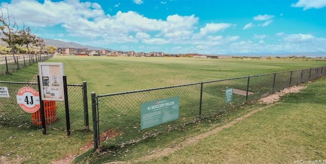 view of property's community with a rural view and a lawn