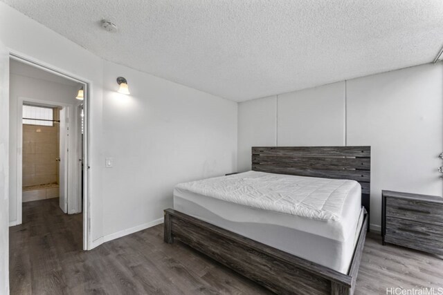 bedroom featuring a textured ceiling and wood-type flooring