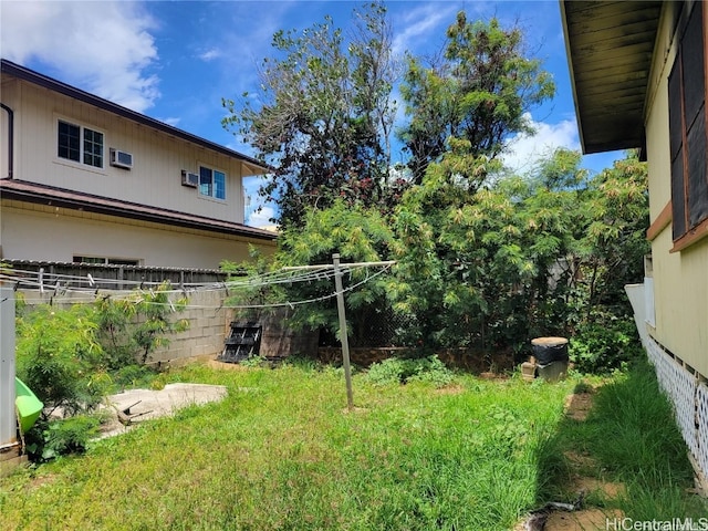 view of yard featuring a wall mounted air conditioner