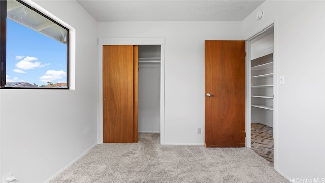 unfurnished bedroom featuring light colored carpet