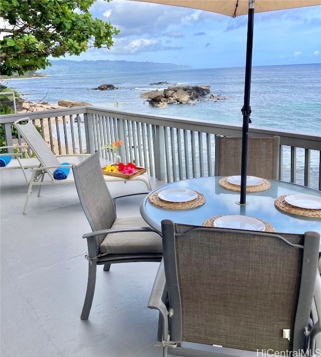 balcony featuring a water view and a view of the beach