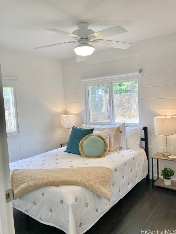 bedroom with multiple windows, dark hardwood / wood-style floors, and ceiling fan