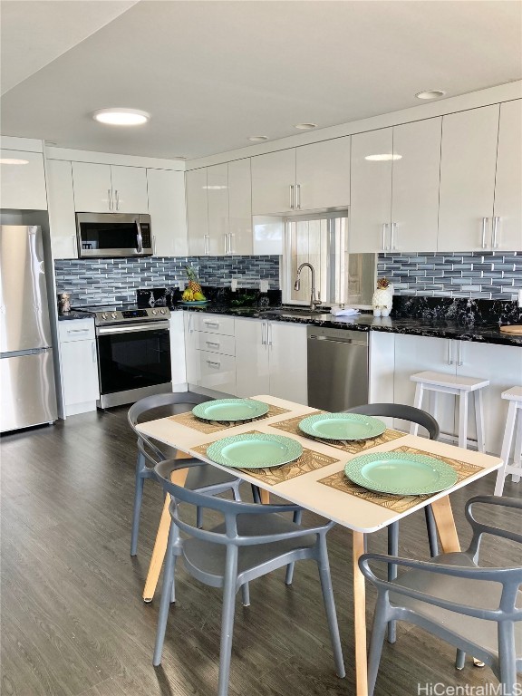 kitchen featuring white cabinetry, tasteful backsplash, and stainless steel appliances