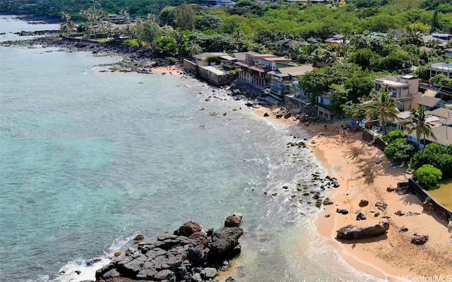 birds eye view of property with a view of the beach and a water view