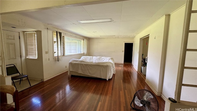 bedroom with dark hardwood / wood-style floors