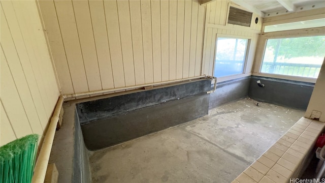 bathroom featuring wooden walls