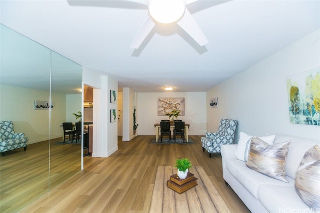 living room with hardwood / wood-style floors and ceiling fan