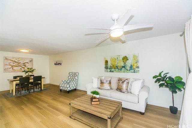 living room with ceiling fan and hardwood / wood-style flooring