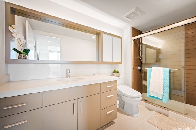 bathroom with vanity, toilet, and walk in shower