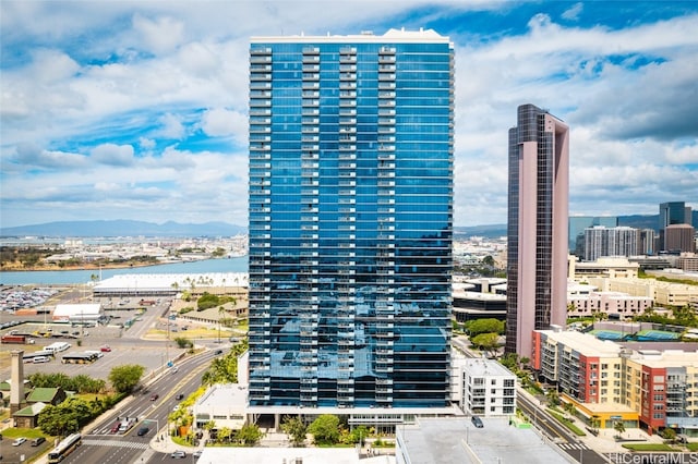 view of building exterior featuring a water and mountain view