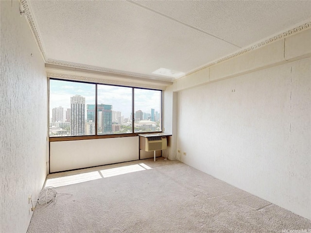 carpeted empty room featuring a textured wall, a wall mounted air conditioner, a city view, and a textured ceiling