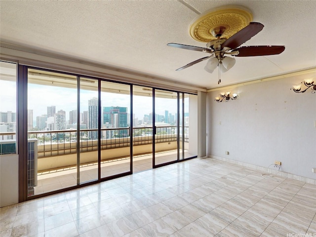 unfurnished room featuring crown molding, a view of city, a textured ceiling, and ceiling fan