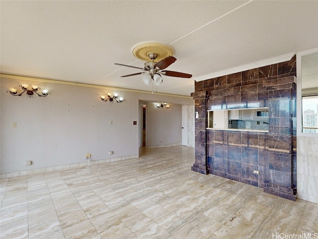 unfurnished living room with crown molding, a textured ceiling, tile walls, and ceiling fan