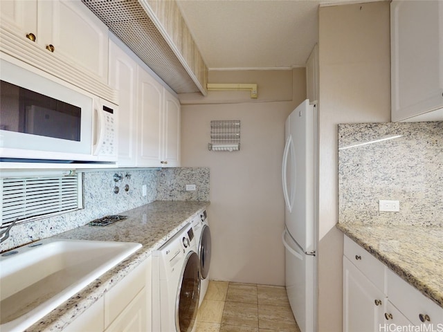 kitchen featuring white appliances, decorative backsplash, sink, and white cabinets