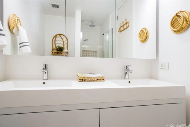 bathroom with vanity and a tile shower