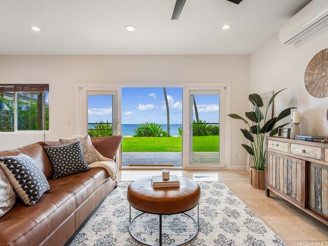 living area with light tile patterned floors, recessed lighting, a water view, and a wall unit AC
