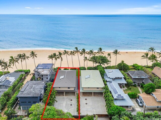 drone / aerial view featuring a beach view and a water view