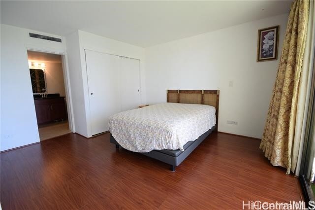 bedroom featuring a closet and dark hardwood / wood-style floors