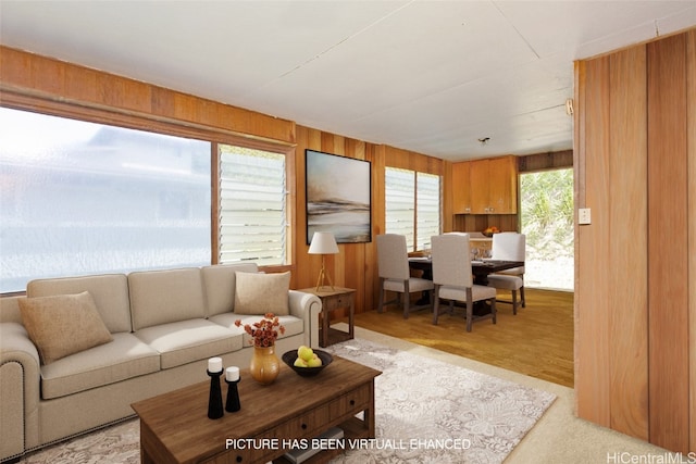 living room with wood walls and light wood-type flooring