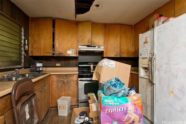 kitchen featuring dark hardwood / wood-style flooring, sink, range with gas stovetop, and white fridge with ice dispenser