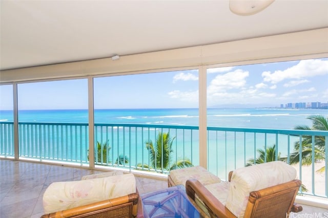 sunroom / solarium featuring a water view