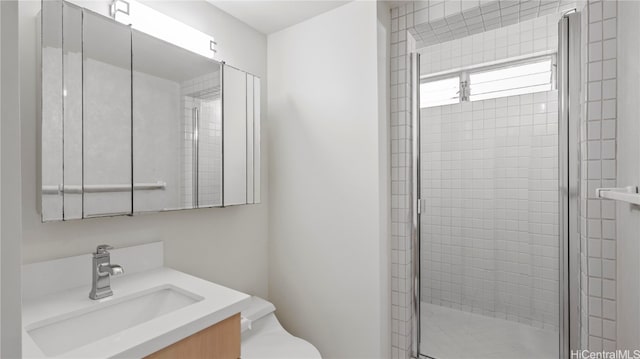 bathroom with vanity, toilet, and walk in shower