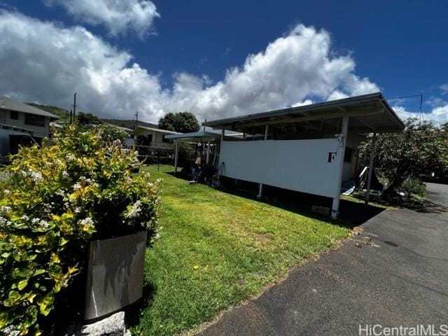 view of home's exterior with a yard