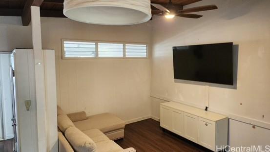 living room with ceiling fan and dark wood-type flooring