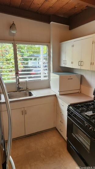 kitchen with white cabinetry, sink, a healthy amount of sunlight, black gas range oven, and wood ceiling