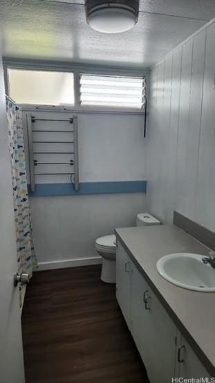 bathroom with vanity, hardwood / wood-style flooring, and toilet