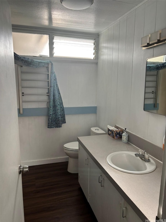 1629 Kino St Unit F, Honolulu, HI 96819 - bathroom with toilet, wood finished floors, vanity, baseboards, and a textured ceiling