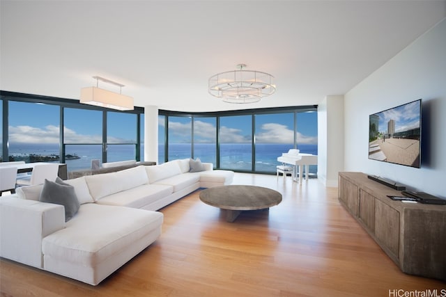 living room with a wall of windows, light hardwood / wood-style flooring, and an inviting chandelier