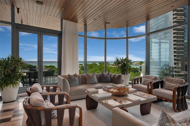 sunroom with a water view and wood ceiling