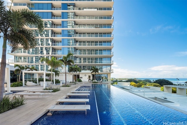 view of swimming pool featuring a water view