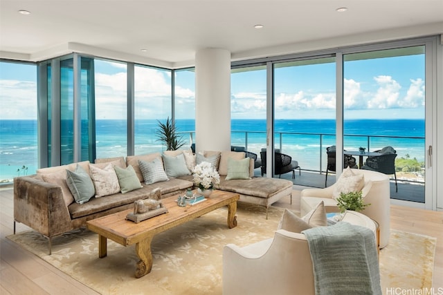 living room with a water view and light wood-type flooring