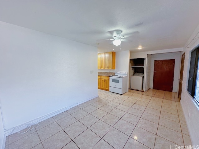 kitchen with washer / clothes dryer, electric stove, ceiling fan, light tile patterned floors, and light brown cabinets