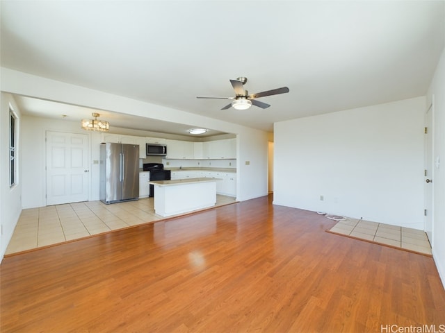 unfurnished living room with light hardwood / wood-style flooring and ceiling fan