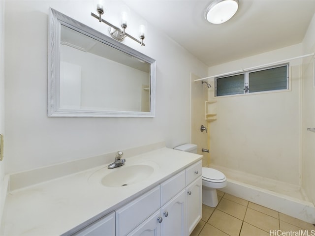 bathroom with toilet, vanity, a shower, and tile patterned flooring