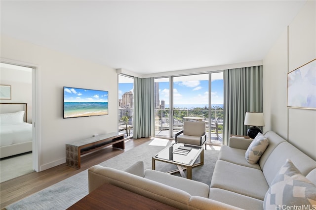 living room with hardwood / wood-style floors and expansive windows