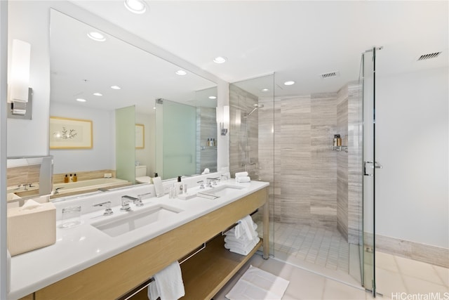 bathroom with vanity, a shower with door, tile patterned flooring, and toilet