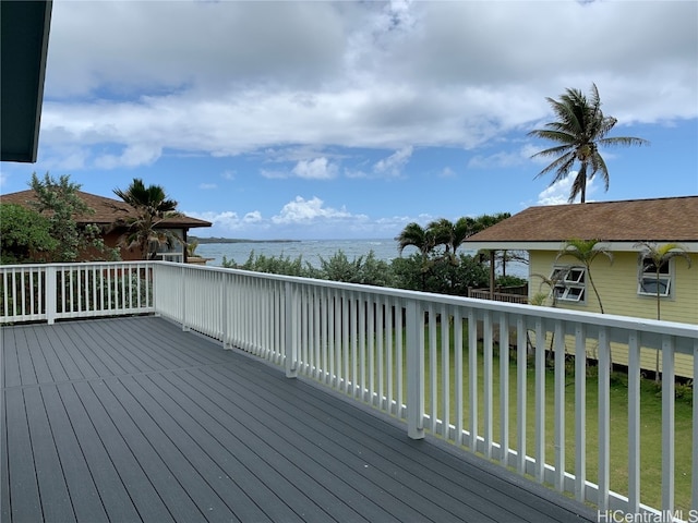 deck with a yard and a water view