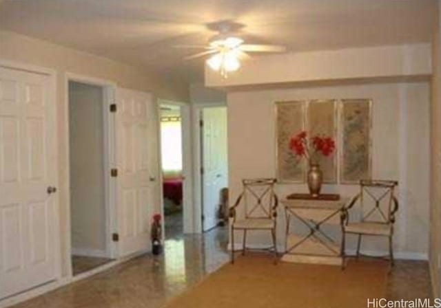 sitting room with ceiling fan