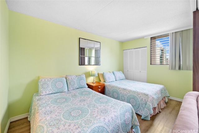 bedroom with a closet and hardwood / wood-style floors