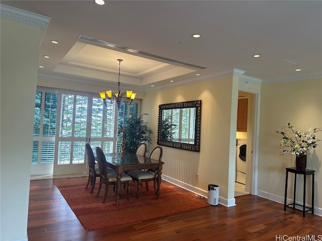 dining area with a wealth of natural light, ornamental molding, washer / dryer, and dark hardwood / wood-style flooring