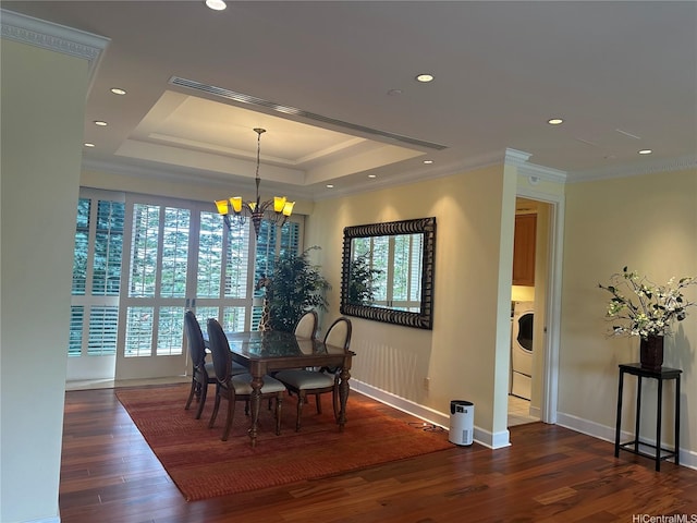1740 S Beretania St Unit 33, Honolulu, HI 96826 - dining space featuring a chandelier, wood finished floors, baseboards, a raised ceiling, and washer / dryer