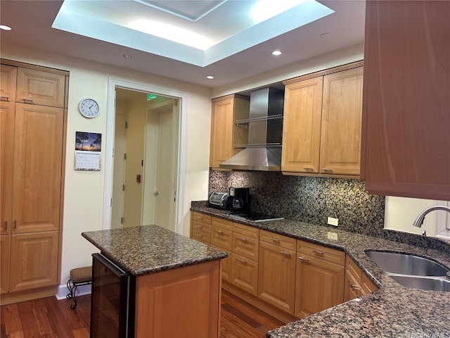 1740 S Beretania St Unit 33, Honolulu, HI 96826 - kitchen featuring wine cooler, a sink, wall chimney range hood, dark wood finished floors, and decorative backsplash